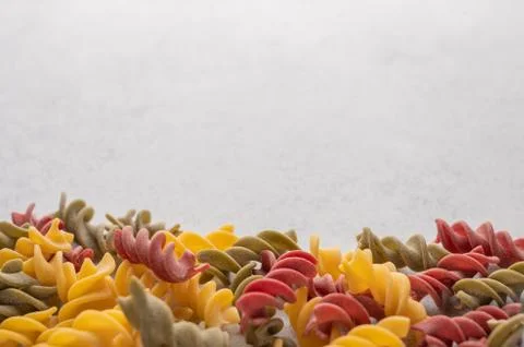 Multicolored pasta background concept on gray background. Diet and healthy food Stock Photos