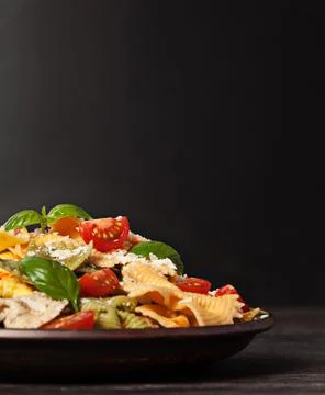 Multicolored pasta on dark background Foto stock