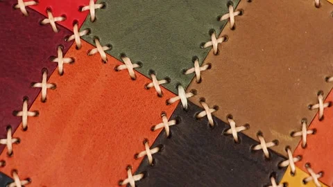 Multicolored patchwork leather with large stitching turns around, close-up view Stockbeeldmateriaal 156474617