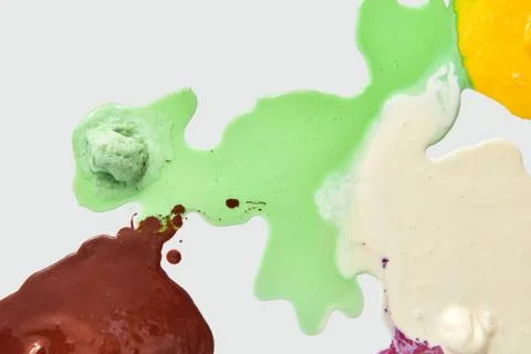 Multicolored pattern of melted ice cream on a white background with copy space Stockfoto's