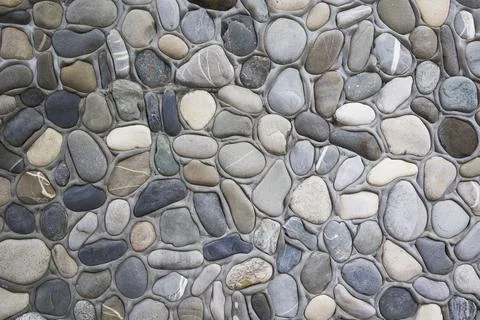 Multicolored pebble stone wall texture background Stock Photos