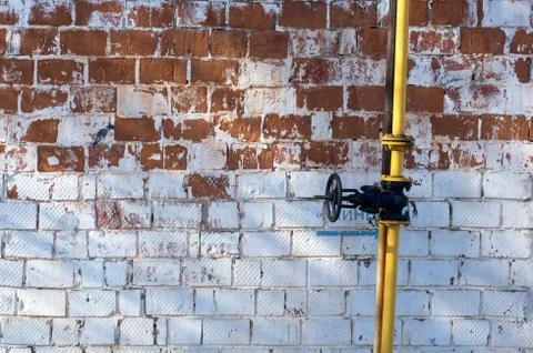 Multicolored peeling wall, yellow pipe, texture and background. Painted bri.. Stock Photos