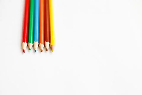Multicolored pencils lying on a white table 写真素材