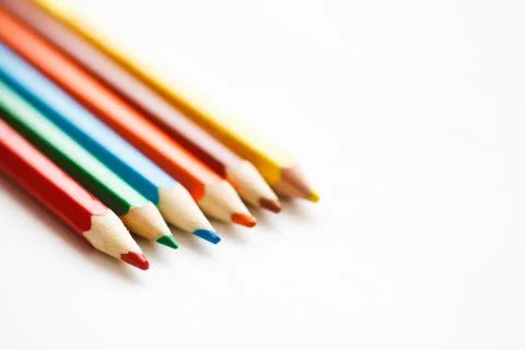 Multicolored pencils lying on a white table 写真素材