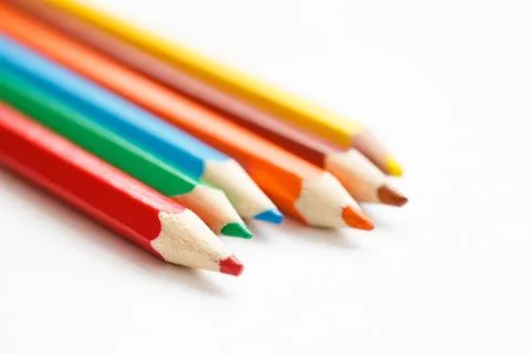 Multicolored pencils lying on a white table 写真素材