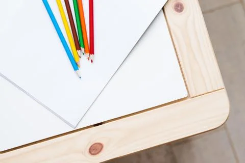 Multicolored pencils lying on a white table Foto stock