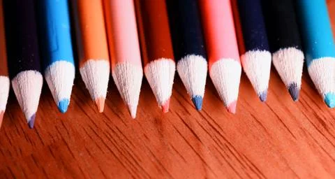 Multicolored pencils on the table. A stack of colored pencils ti Stock Photos