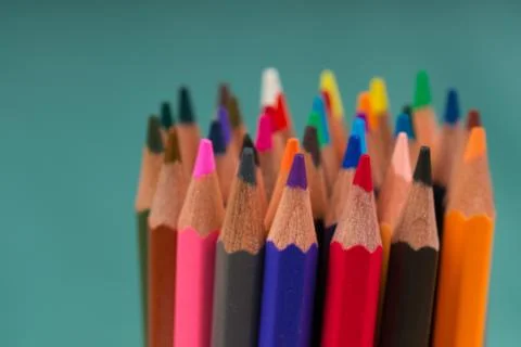 Multicolored pensils on a blue background. Stock Photos