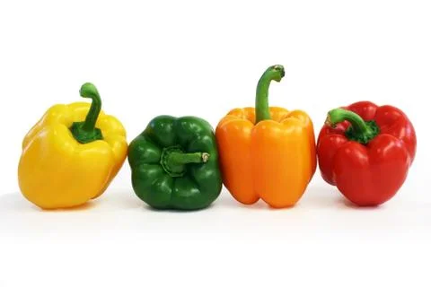 Multicolored peppers lined up Stock Photos