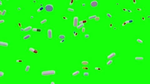 Multicolored pills and capsules falling down smoothly on green screen background Stock Footage 313547830