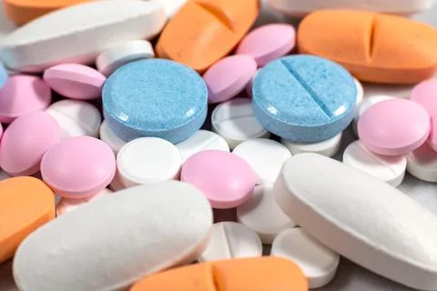 Multicolored pills on the table 스톡 사진