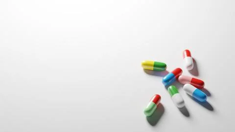Multicolored pills on white background with plenty of negative space. Digital Stock Illustration