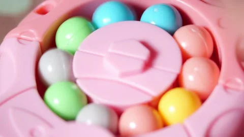 Multicolored Plastic Balls Rotating Inside Pink Anti Stress Toy with Whirring Stock Footage 321527933