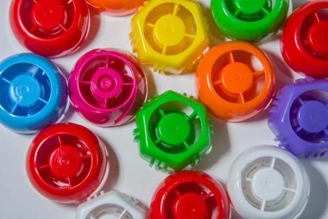 Multicolored plastic bottle caps background. Texture for design. Recycling co Stock Photos