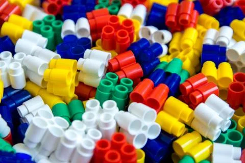 Multicolored plastic building blocks of the designer. Background of plastic c Stock Photos