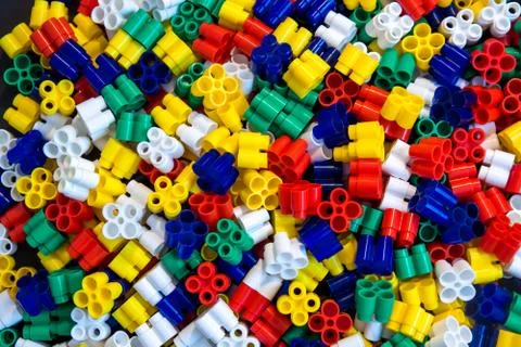 Multicolored plastic building blocks of the designer. Background of plastic c Stock Photos