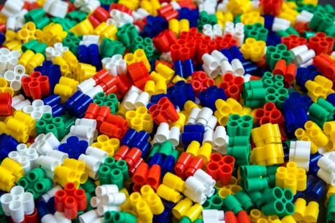 Multicolored plastic building blocks of the designer. Background of plastic c Stock Photos