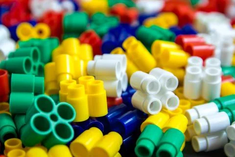 Multicolored plastic building blocks of the designer. Background of plastic c Stock Photos
