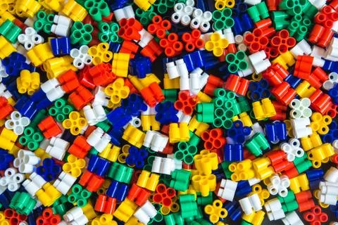 Multicolored plastic building blocks of the designer. Background of plastic c Stock Photos
