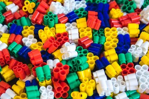Multicolored plastic building blocks of the designer. Background of plastic c Stock Photos