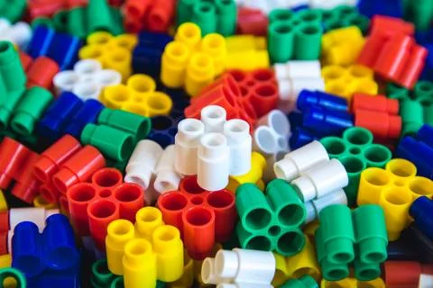 Multicolored plastic building blocks of the designer. Background of plastic c Stock Photos