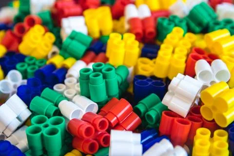 Multicolored plastic building blocks of the designer. Background of plastic c Stock Photos