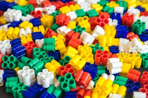 Multicolored plastic building blocks of the designer. Background of plastic c Stock Photos