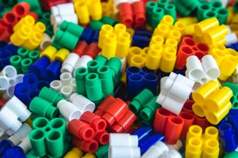 Multicolored plastic building blocks of the designer. Background of plastic c Stock Photos