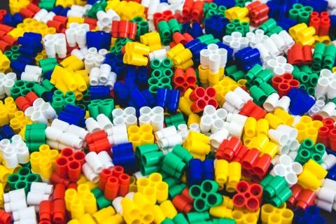 Multicolored plastic building blocks of the designer. Background of plastic c Stock Photos