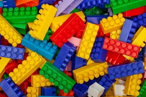 Multicolored plastic building blocks of the designer Stock Photos