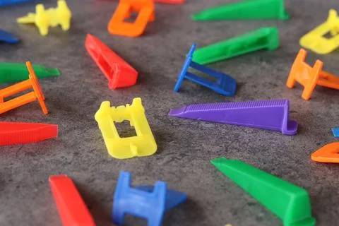 Multicolored plastic clips and wedges of tile leveling system Stock Photos