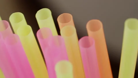 Multicolored plastic cocktail straws, close up, camera movement, rack focus Stock Footage 143158615