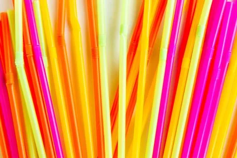 Multicolored plastic drinking cocktail straws pattern, top view. Make a cockt Stock Photos