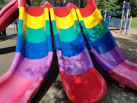 Multicolored plastic slides on playground Stock Photos