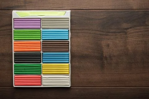 Multicolored plasticine bars on the table Stock Photos