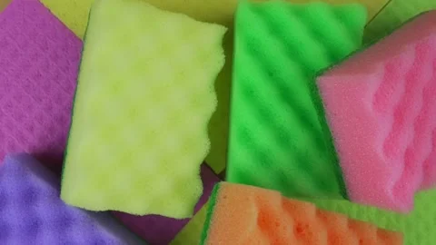 Multicolored polyurethane cleaning kitchen sponges on rag background. Video stock 167279197