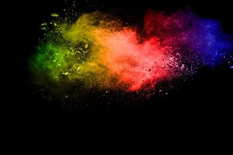 Multicolored powder explosion on black background. Illustrazione stock