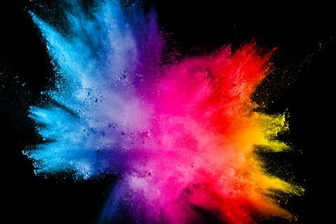 Multicolored powder explosion on black background. Stock Photos