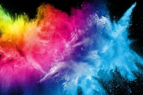 Multicolored powder explosion on black background. Stock Photos