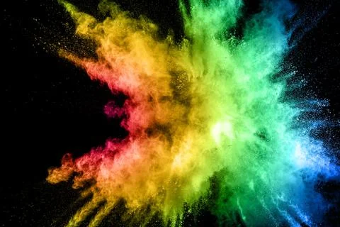 Multicolored powder explosion on black background. Stock Photos