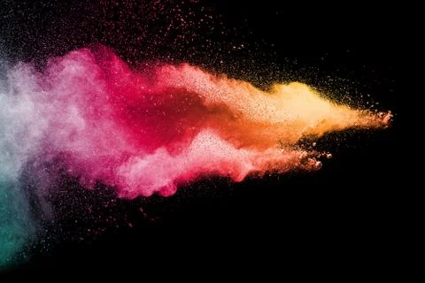 Multicolored powder explosion on black background. Stock Photos