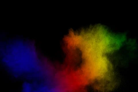 Multicolored powder explosion on black background. Stock Photos
