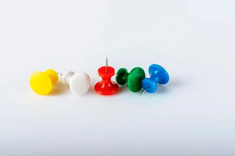 Multicolored push pins on white background. Close-up. 스톡 사진