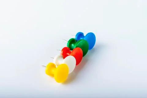 Multicolored push pins on white background. Close-up. 스톡 사진