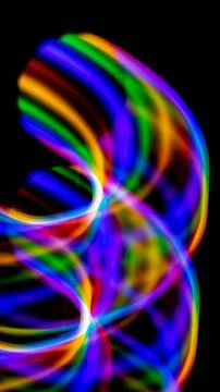 Multicolored rainbow lines on black background Stock Illustration