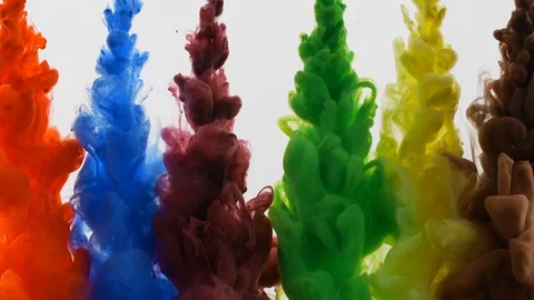 Multicolored rainbow paint drops from above mixing underwater, colored smoke Stock Footage 128587937