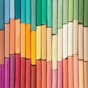 Multicolored rainbow pastel crayons in rows as background Stock Photos