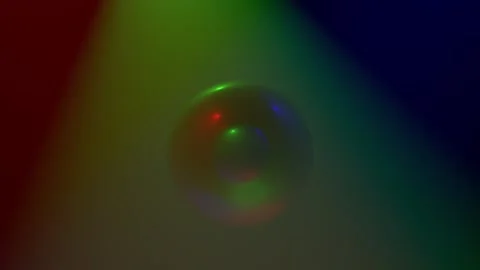 Multicolored rays alternately wash a glossy ball enclosed in another ball Stock Footage 152577528