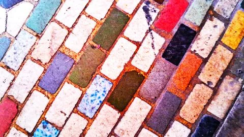 Multicolored rectangular tiles arranged in a decorative mosaic floor pattern Stock Photos