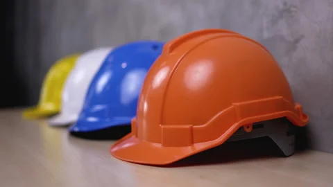 Multicolored Safety Construction Worker Hats. Teamwork of the construction team Stock Footage 150645256